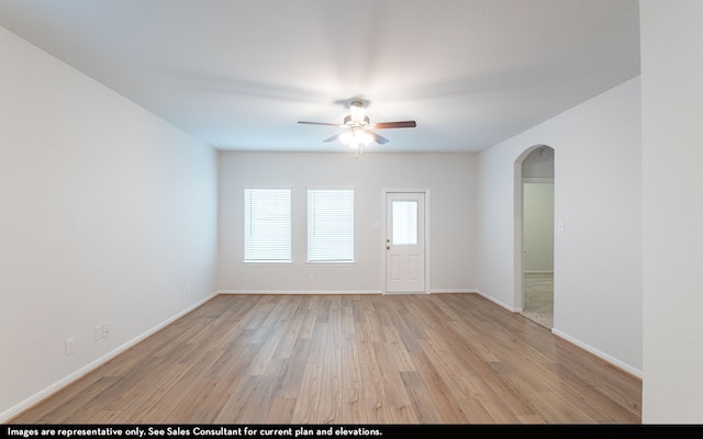 spare room featuring light wood-type flooring and ceiling fan