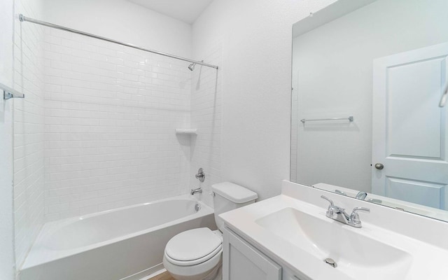 full bathroom featuring tiled shower / bath combo, vanity, and toilet