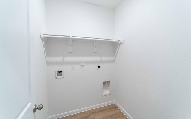 clothes washing area with washer hookup, hookup for a gas dryer, hookup for an electric dryer, and hardwood / wood-style flooring