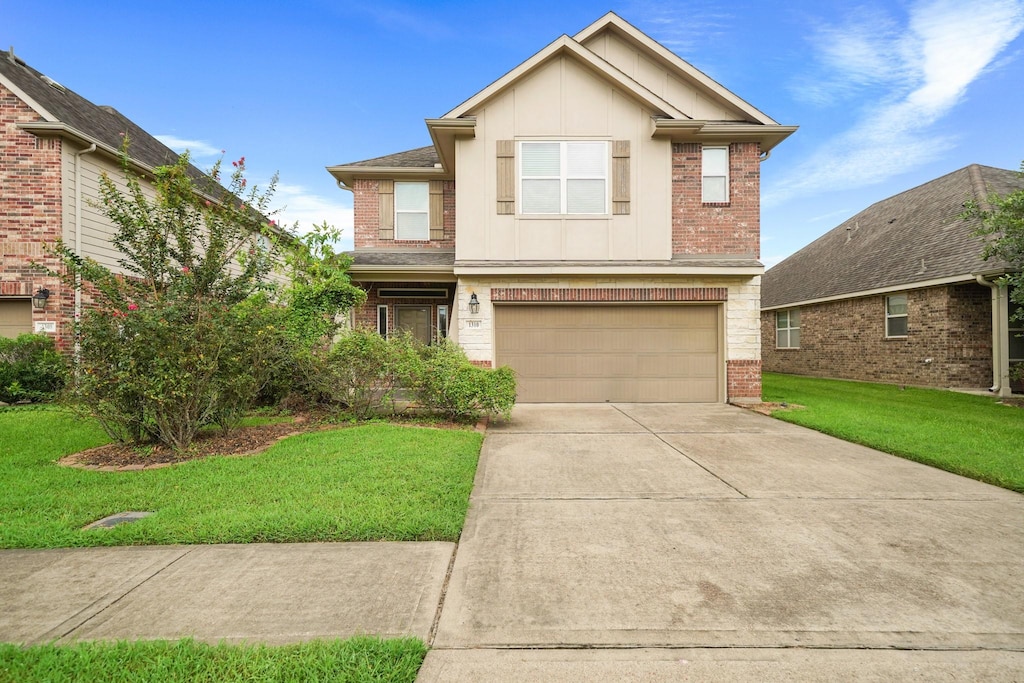 view of front of house featuring a garage and a front lawn