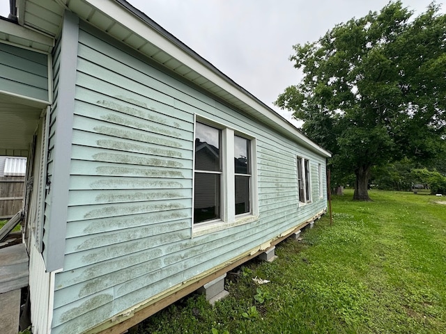 view of side of property with a yard