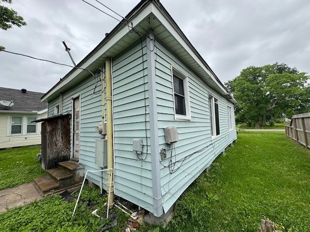 view of side of property with a yard