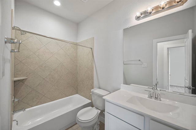 full bathroom featuring toilet, tiled shower / bath, and vanity