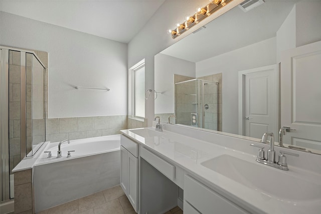 bathroom with shower with separate bathtub, vanity, and tile patterned flooring