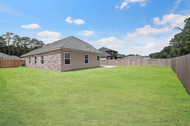 back of property featuring central AC unit and a lawn