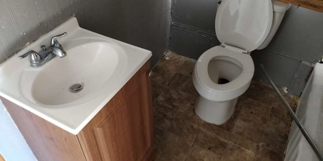 bathroom featuring tile patterned floors, toilet, and vanity