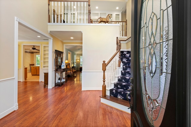 entrance foyer featuring crown molding, hardwood / wood-style floors, and ceiling fan