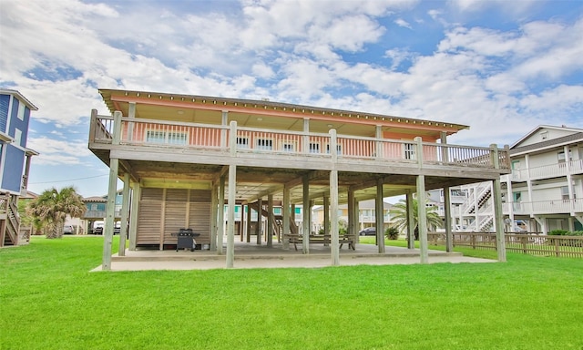 back of property with a patio and a lawn