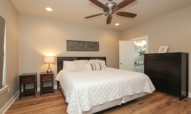 bedroom featuring hardwood / wood-style floors, ensuite bath, and ceiling fan