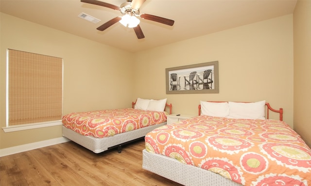 bedroom with light hardwood / wood-style flooring and ceiling fan