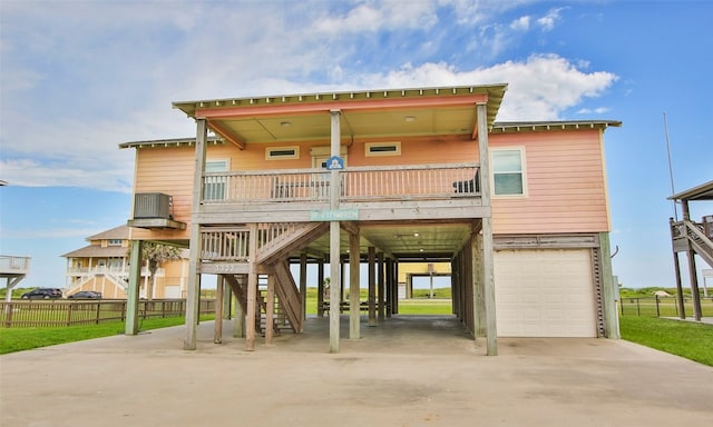 coastal inspired home with a carport, a garage, and covered porch