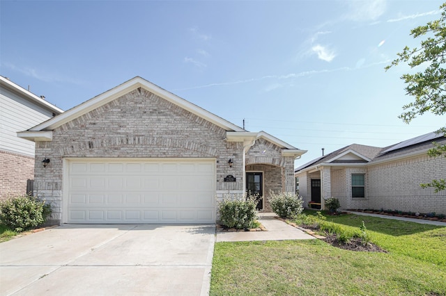 view of front of house with a front yard and a garage