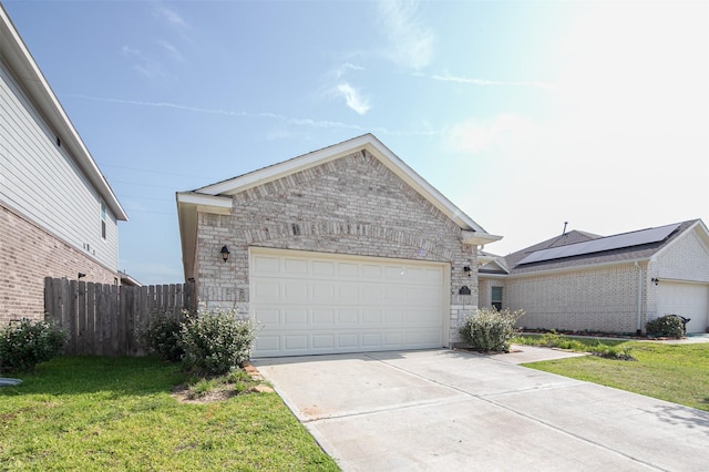 ranch-style home with a garage and a front lawn