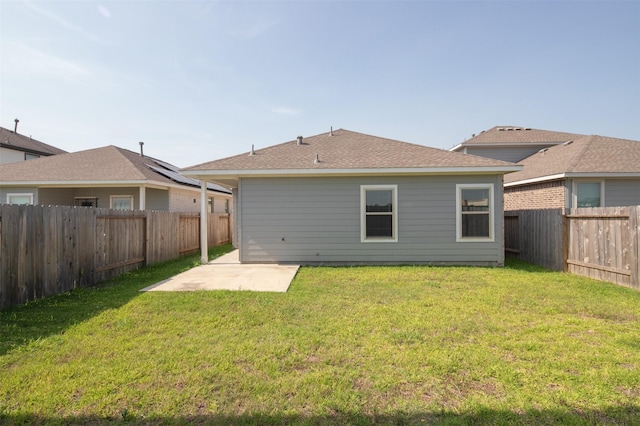 rear view of property with a patio area and a lawn