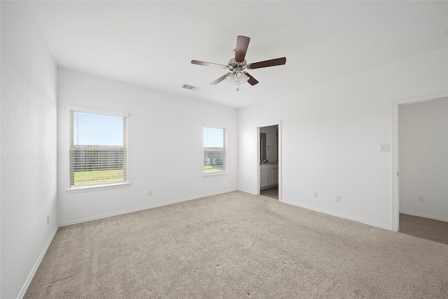 empty room featuring light carpet and ceiling fan