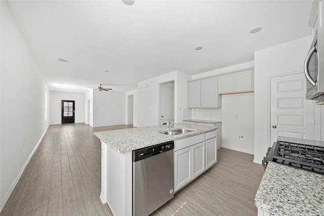 kitchen featuring a center island with sink, stainless steel appliances, white cabinetry, and sink