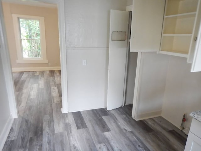 interior space with white cabinets and hardwood / wood-style floors