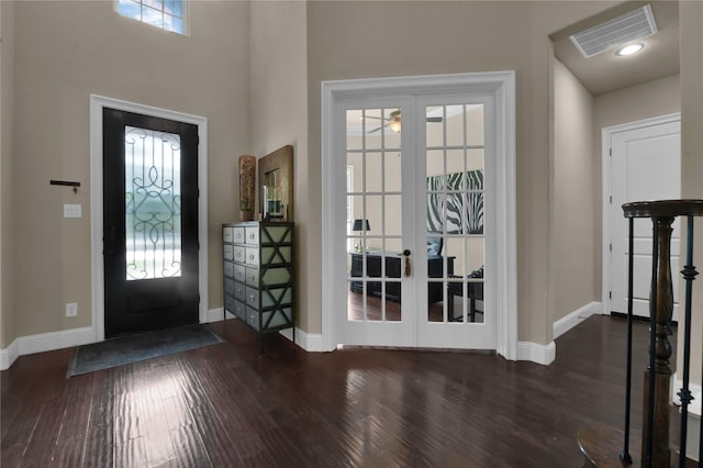 entrance foyer featuring a healthy amount of sunlight, french doors, and dark wood-type flooring