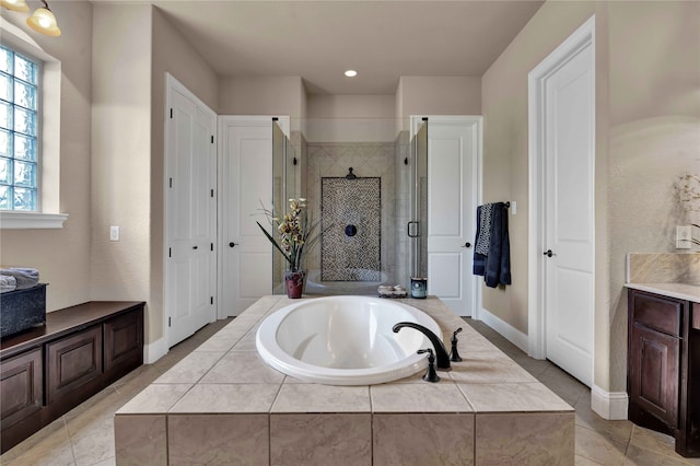 bathroom featuring separate shower and tub and vanity