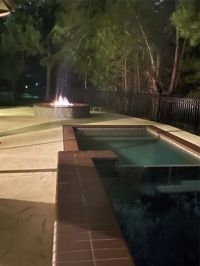 view of pool at night