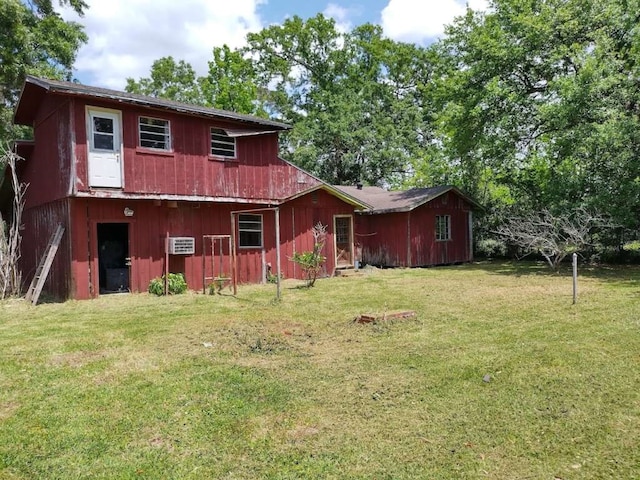 back of property featuring a lawn