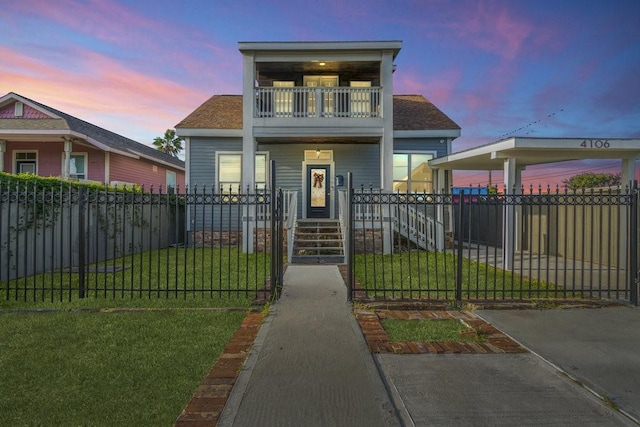 4106 Winnie St, Galveston, TX 77550 - view of front of house with a balcony, a gate, a lawn, and a fenced front yard