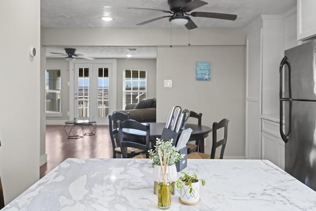 dining space featuring french doors, dark hardwood / wood-style flooring, and ceiling fan