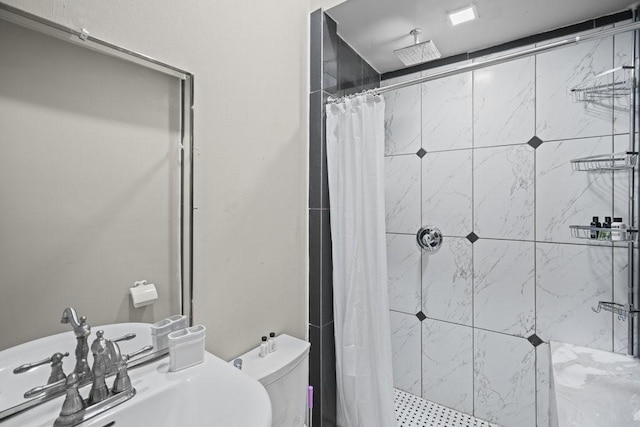 bathroom featuring toilet, sink, and walk in shower