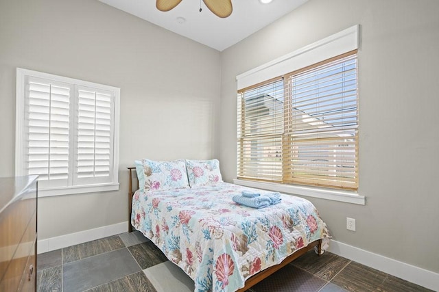 bedroom featuring multiple windows and ceiling fan