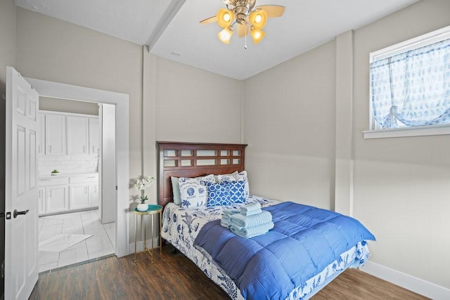 bedroom featuring ensuite bathroom, ceiling fan, and dark hardwood / wood-style floors