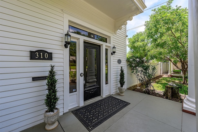 doorway to property featuring fence