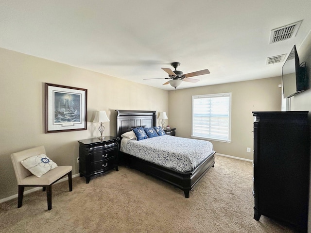 bedroom with light colored carpet, visible vents, ceiling fan, and baseboards