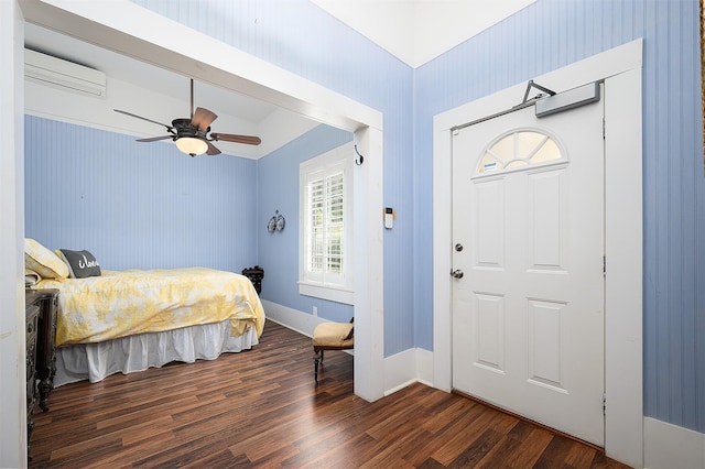 entryway featuring dark wood-style floors, a wall unit AC, and a ceiling fan