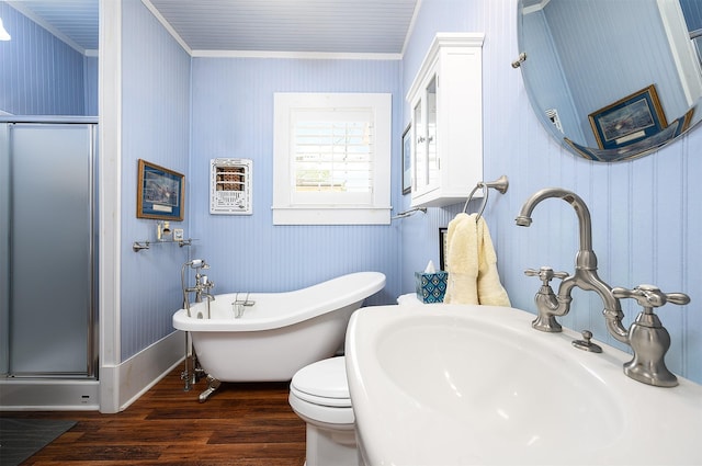 bathroom with crown molding, wood finished floors, a sink, and a shower stall