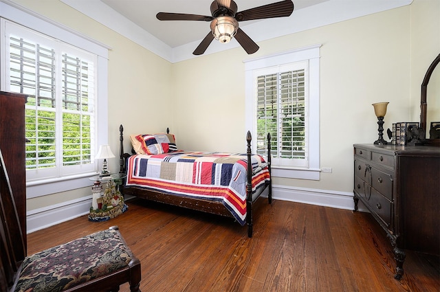 bedroom with a ceiling fan, baseboards, and wood finished floors