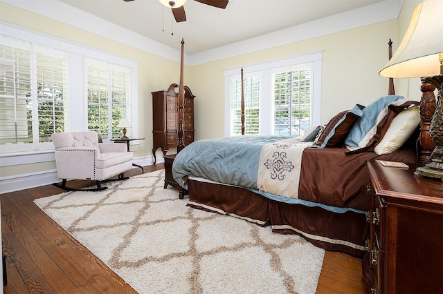 bedroom with ceiling fan, hardwood / wood-style flooring, and baseboards