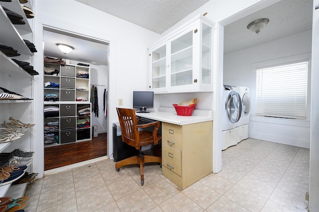 home office with light floors, washing machine and dryer, baseboards, and a textured ceiling