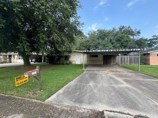 view of front of property with a carport and a front lawn