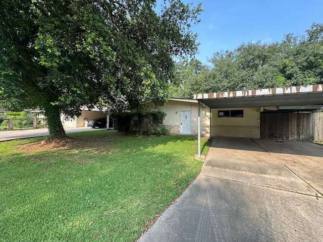 view of front of property with a carport and a front lawn