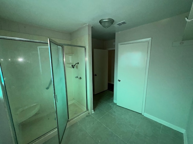 bathroom featuring an enclosed shower and tile patterned floors