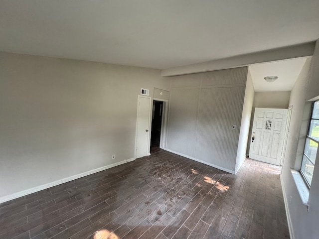 interior space with dark hardwood / wood-style flooring and vaulted ceiling