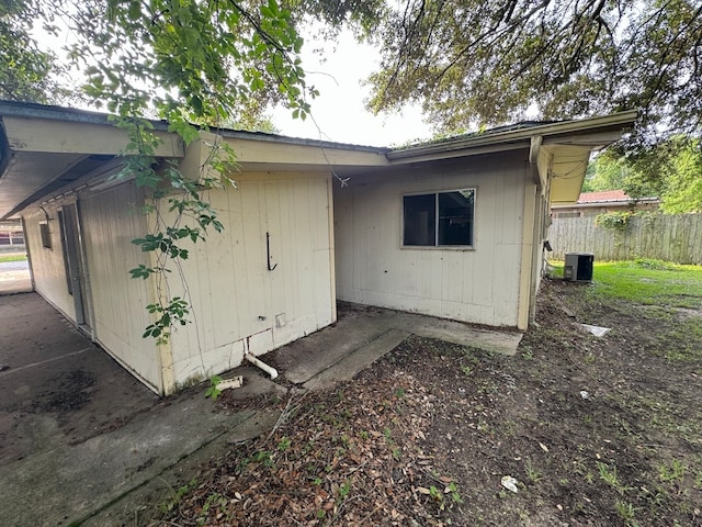 rear view of property with central AC