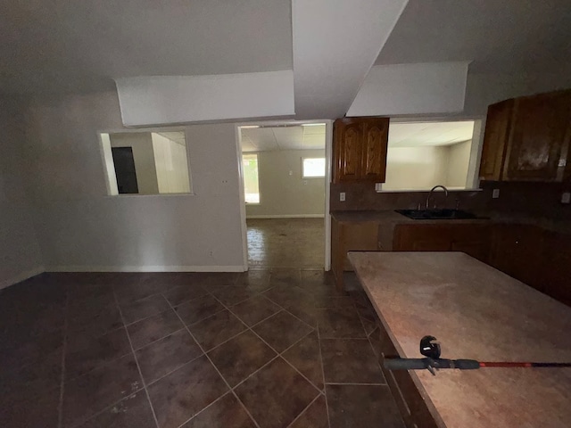 kitchen with sink and dark tile patterned floors