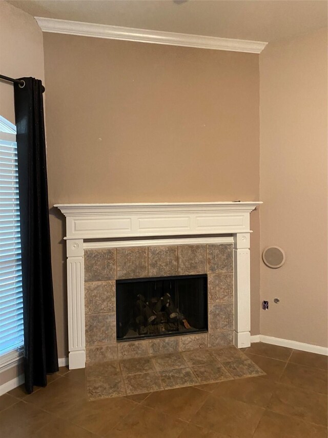 room details with tile patterned floors, a tiled fireplace, and crown molding