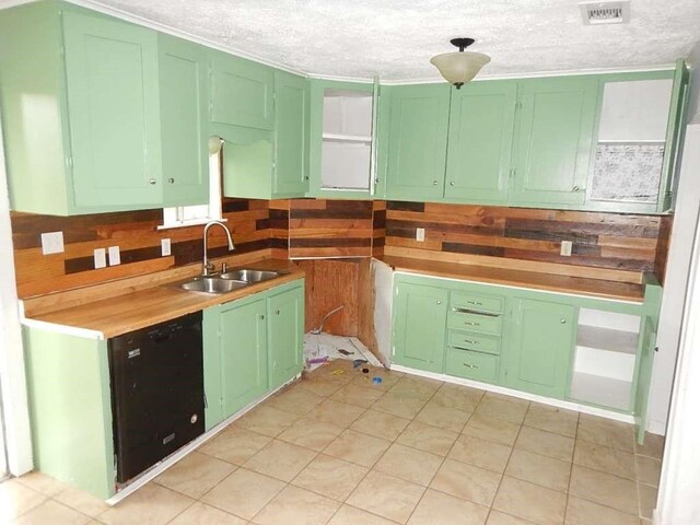 kitchen with green cabinets, sink, and dishwasher