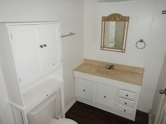 bathroom with vanity, wood-type flooring, and toilet