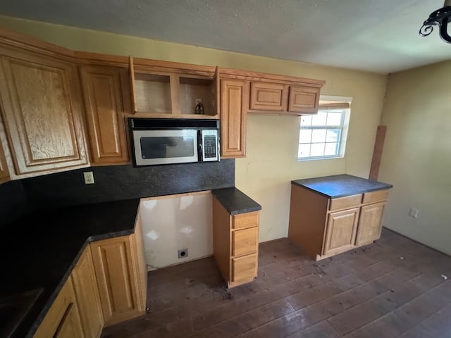 kitchen with dark wood-type flooring