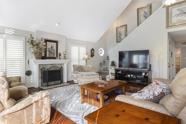 living room with wood-type flooring, a fireplace, and high vaulted ceiling