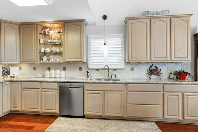 kitchen with light brown cabinets, pendant lighting, sink, stainless steel dishwasher, and dark wood-type flooring