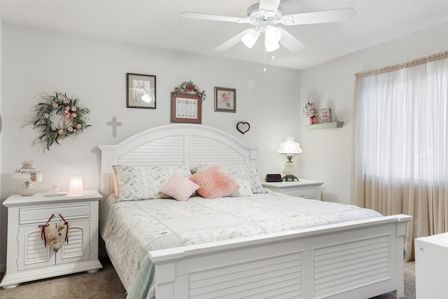 bedroom featuring dark carpet and ceiling fan